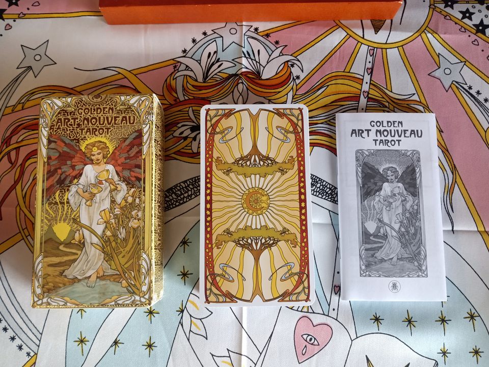 Golden Art Nouveau tuckbox, tarot deck with card backs showing, and LWB.